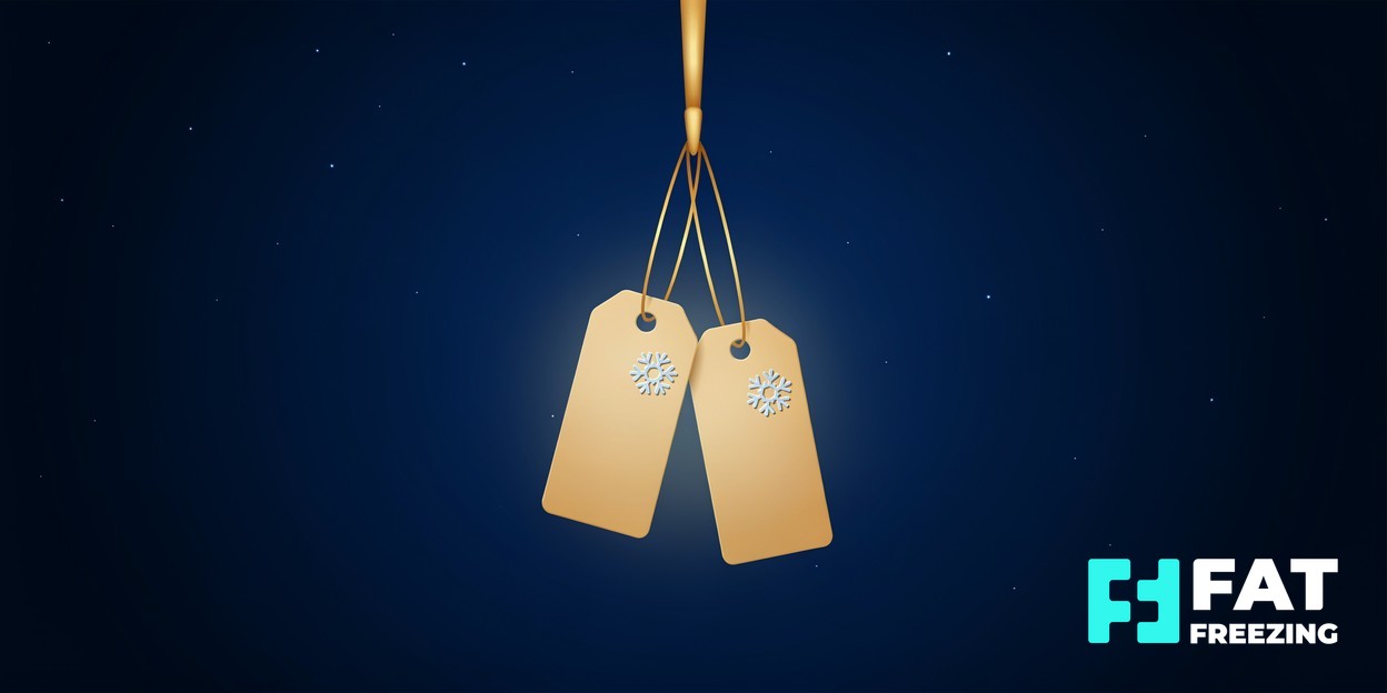 Two blank gold price tags hanging together beneath a hook.